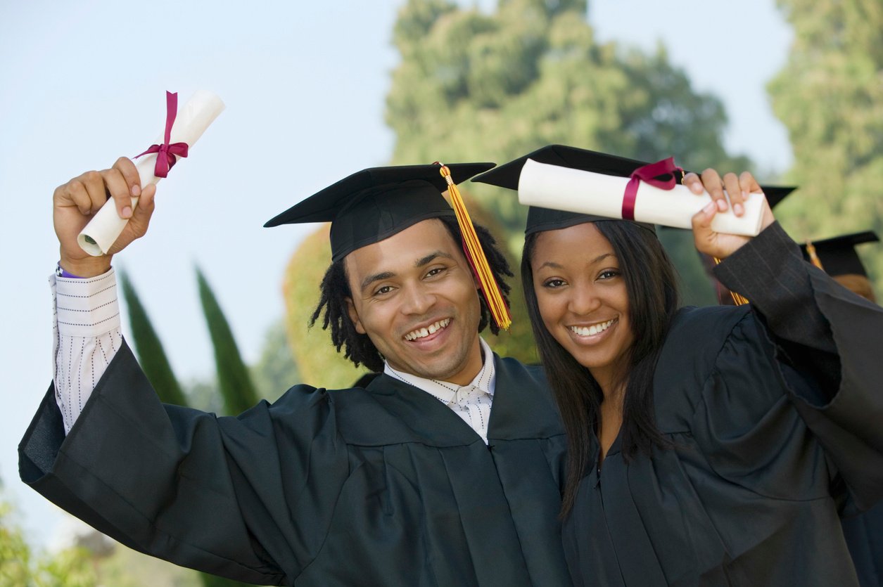 Students Holding Diplomas on Graduation Day